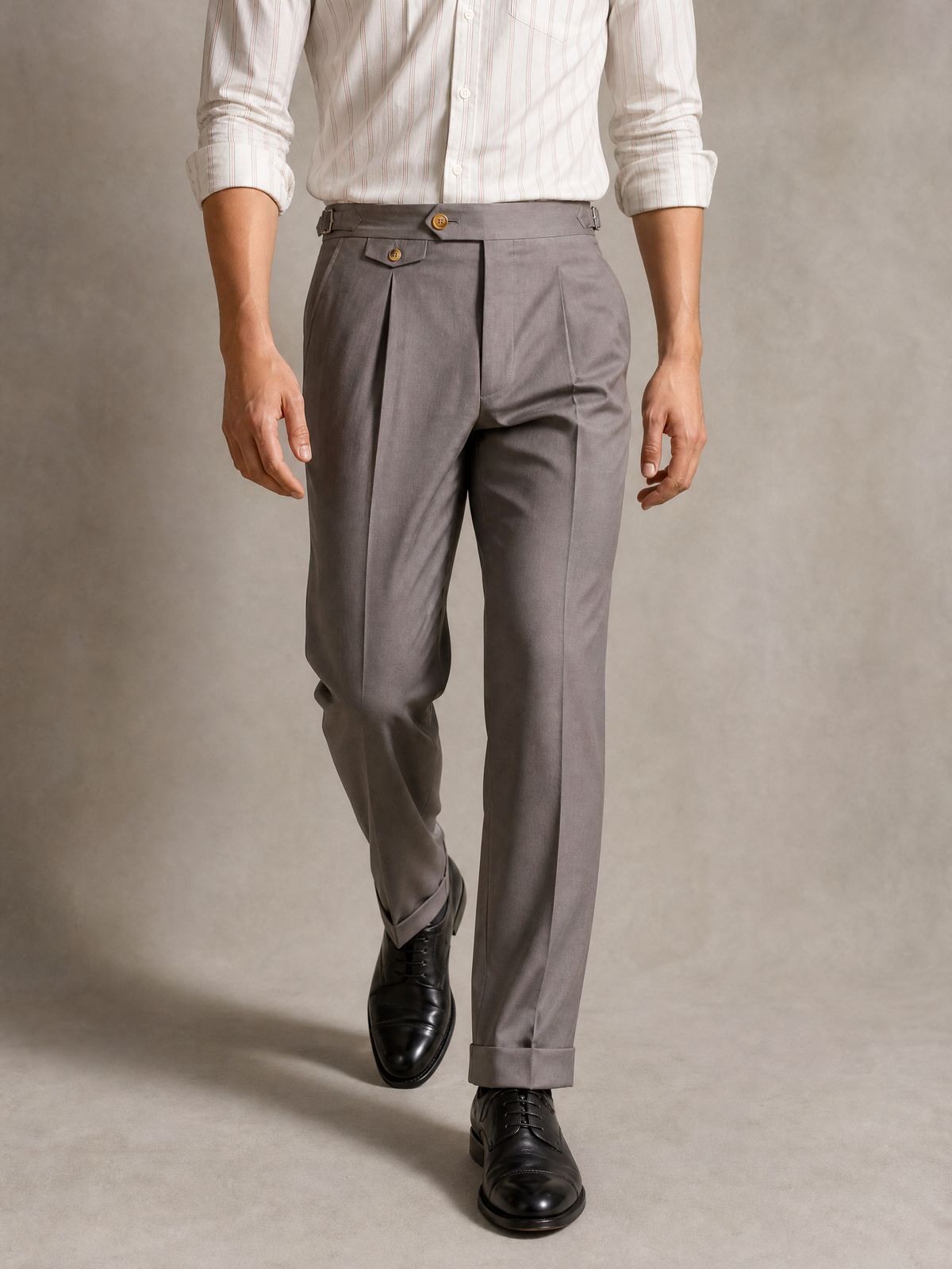 Cotton twill trouser in taupe — high-rise single pleat with side adjusters and turn-up cuffs